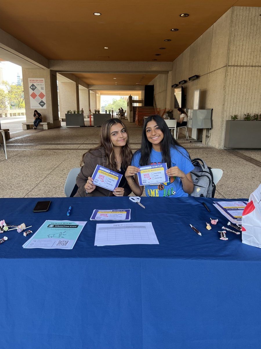 Two students at an NAAIS voter registration table
