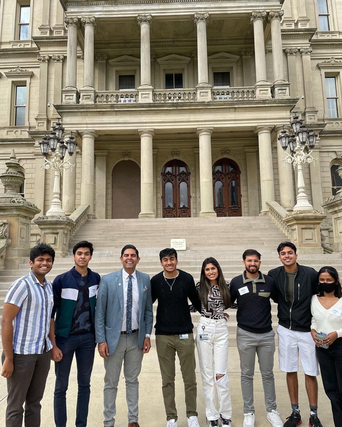 NAAIS students with a legislator on the steps of the Michigan State Capitol