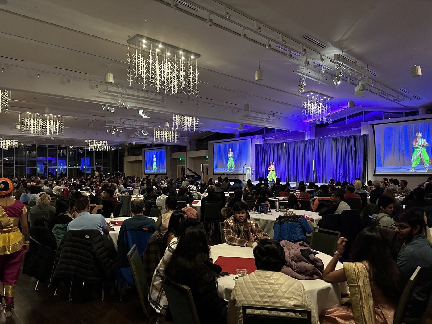 A packed ballroom at an NAAIS community event