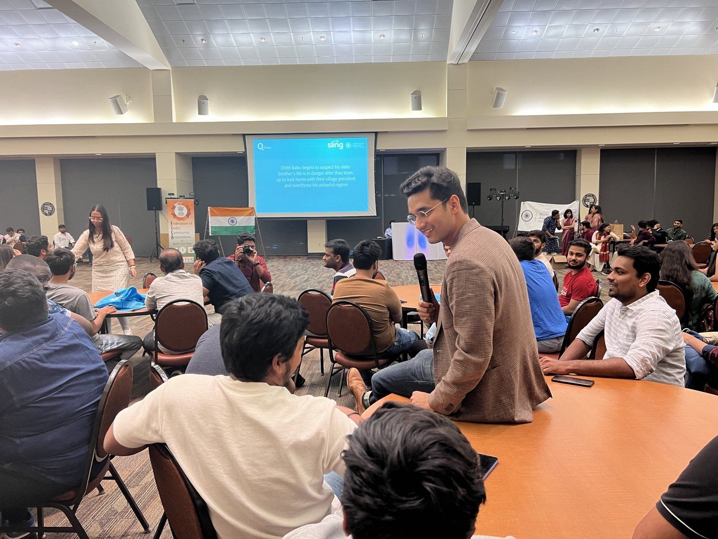Sudhanshu Kaushik speaking with students seated at round tables