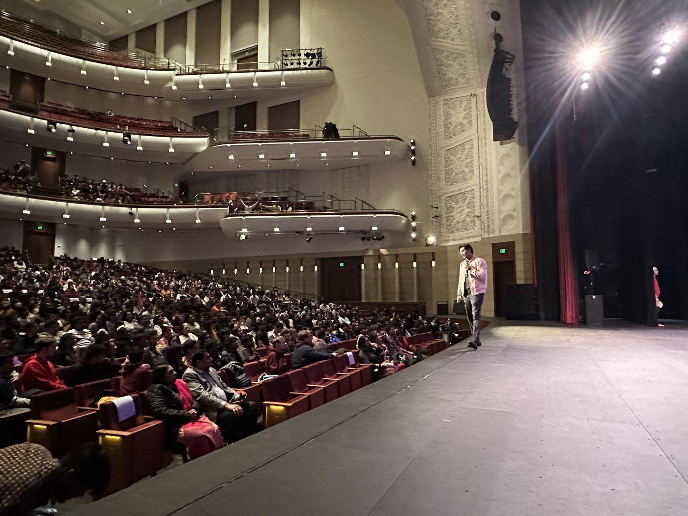 A full theatre audience at an NAAIS event